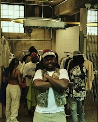 a man standing in front of a room full of clothes